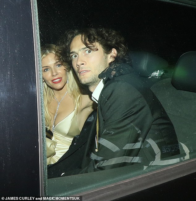 Sienna Miller, 40, cosies up to her new man Oli Green, 25, in the backseat of a car after the BAFTAs
