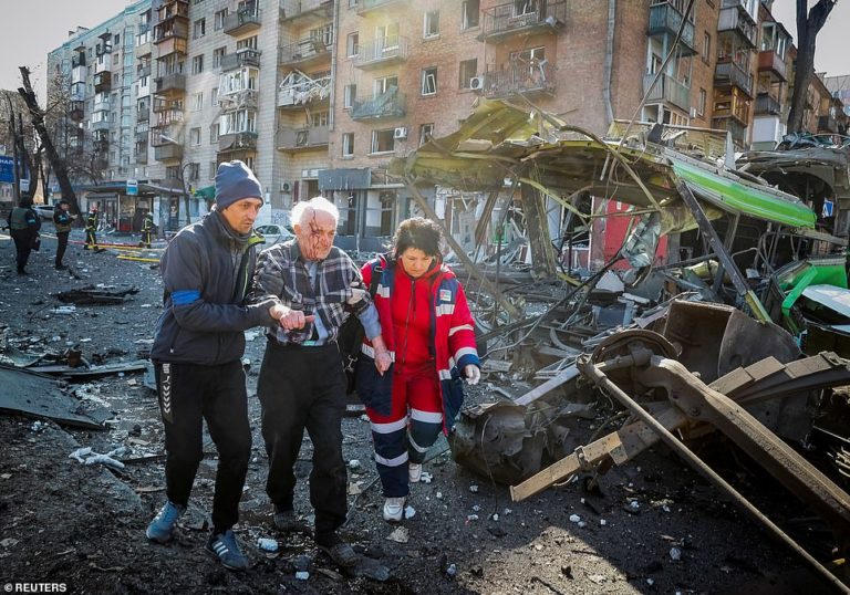 Bombs rain down on Kyiv apartment block, killing two as Putin’s forces edge closer to capital
