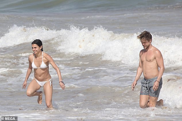 Derek Hough and girlfriend Hayley Erbert splash in the waves and soak up the sun in Tulum
