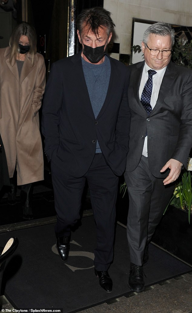 Sean Penn looks dapper in a dark suit as he grabs dinner in London with a mystery woman
