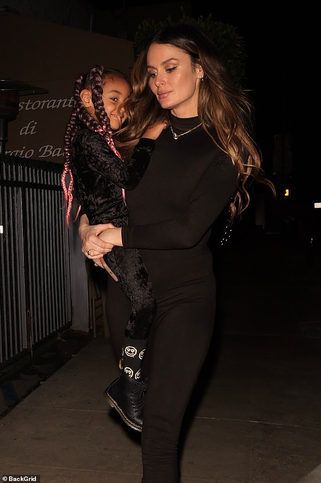 Nicole Trunfio shows off her incredible figure in a black catsuit as she dotes on her daughter Gia