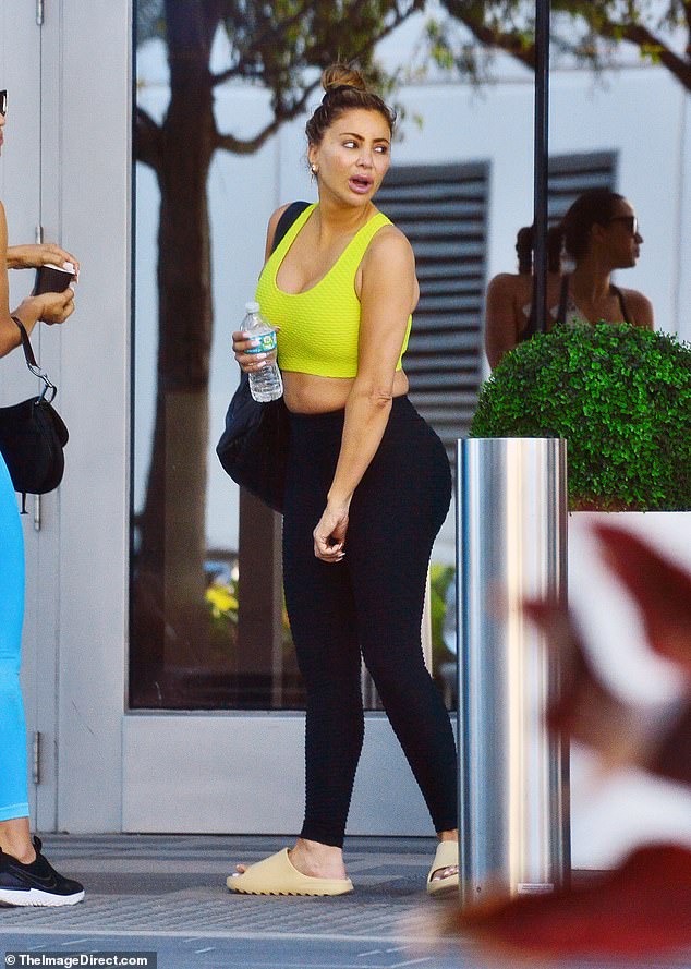 RHOM’s Larsa Pippen shows off her flat abs in a yellow sports bra at the gym with a friend in Miami