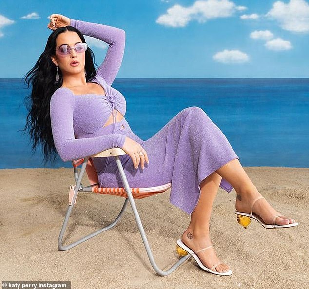 Katy Perry is seen in a form-fitting purple dress as she models sandals