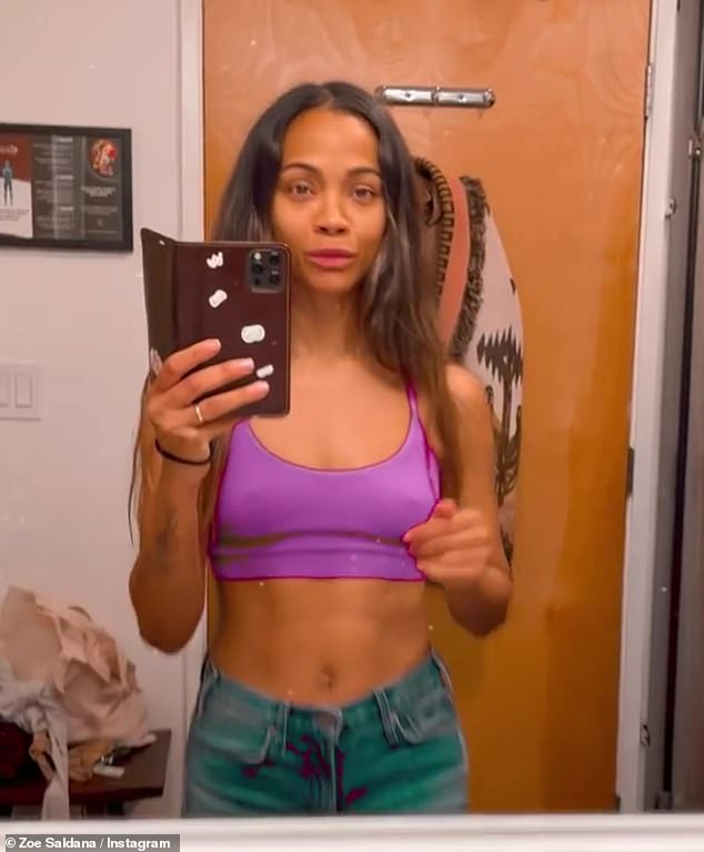 Zoe Saldana flashes her toned abs as she entertains her children by letting them paint her face