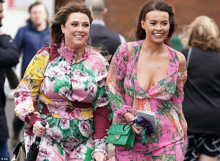 Racegoers brave the drizzle as they arrive at Aintree for the Grand National