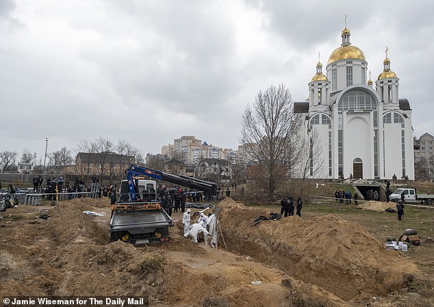 In the shadow of a gilt-domed church in Bucha, a new mass grave gives up its dead