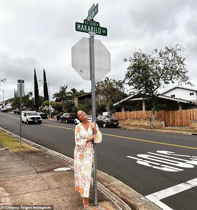 Chrissy Teigen walks down memory lane as she visits the street where she lived as a child in Hawaii