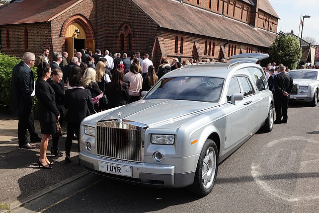 Travellers wearing pink follow seven Rolls Royce cars at funeral of grandmother who died of cancer