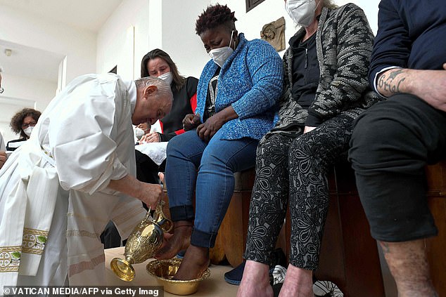 Pope Francis washes the feet of a dozen inmates at a Rome prison