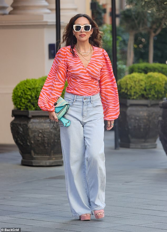 Myleene Klass embraces the spring sunshine in a 70s-inspired pink striped blouse and boyfriend jeans