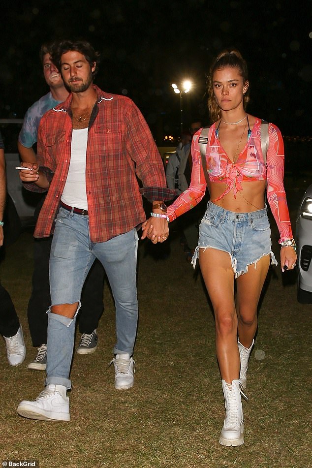 Nina Agdal holds hands with handsome mystery man at Coachella music festival