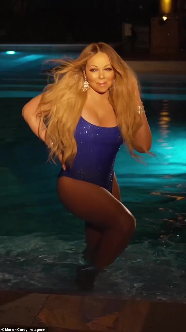 Mariah Carey emerges from crystal clear pool in sparkling purple one-piece bathing suit