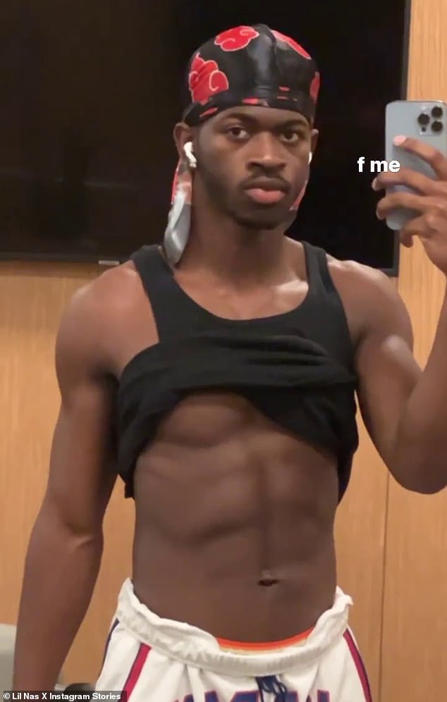 Lil Nas X shows off his washboard abs in a shirtless Instagram selfie during an intense workout