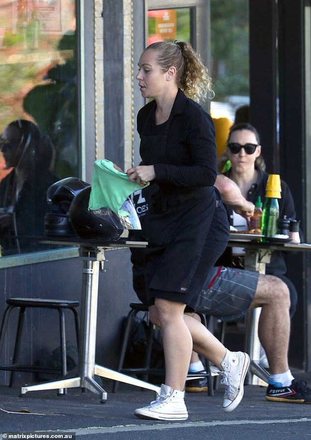 Jessica Marais cleans tables and serves drinks while waitressing