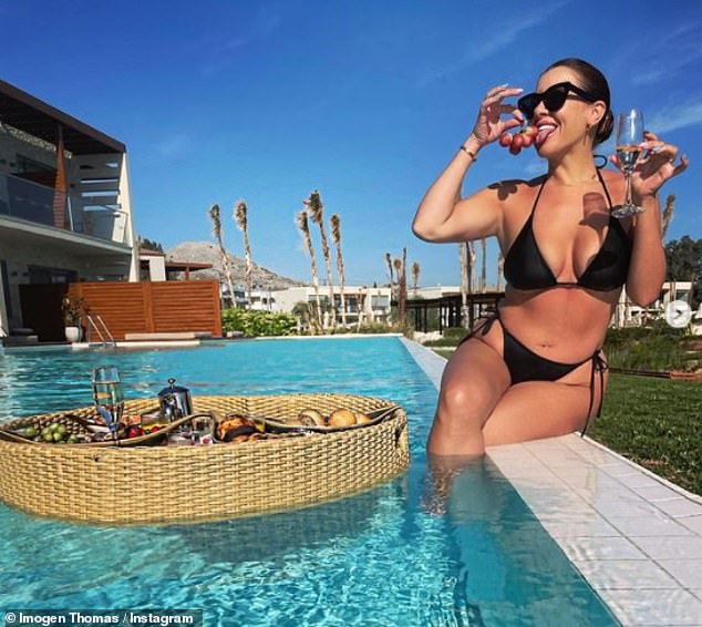Imogen Thomas shows off her enviable assets in a skimpy black bikini on her Greek getaway