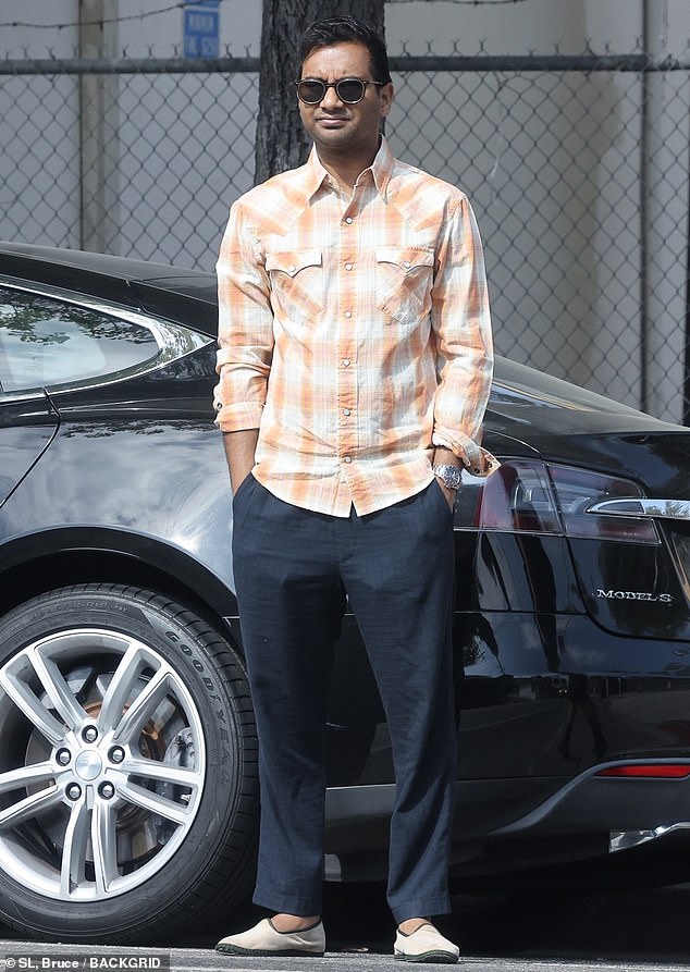Aziz Ansari cuts a very casual figure in a flannel shirt while picking up pastries in LA