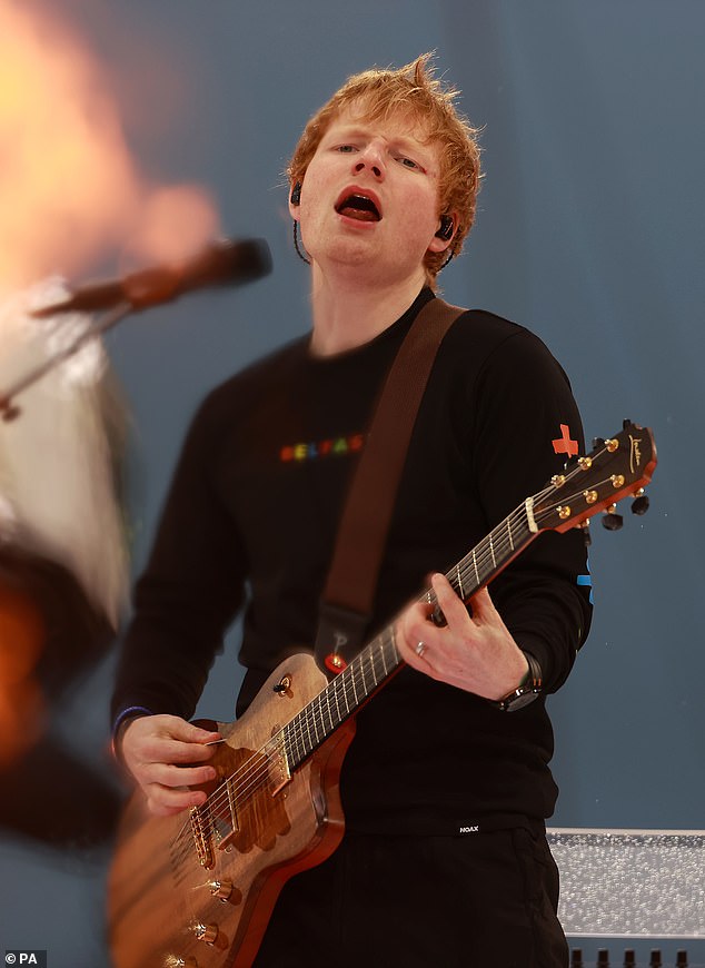 Ed Sheeran takes to the stage while surrounded by flames on his live Mathematics tour