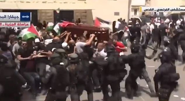 Israeli forces clash with funeral procession of Al Jazeera journalist and almost topple her CASKET