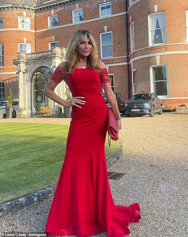 Lizzie Cundy stuns in a backless red gown with a bardot neckline to host cancer charity ball 