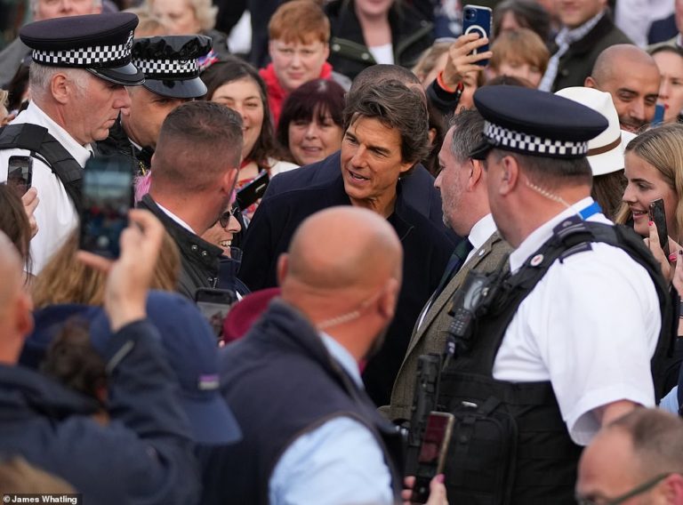 Tom Cruise protected by police after being mobbed by eager fans while WALKING through Windsor
