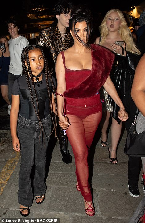Kourtney Kardashian looks sensational in a sheer red dress as she steps out for dinner