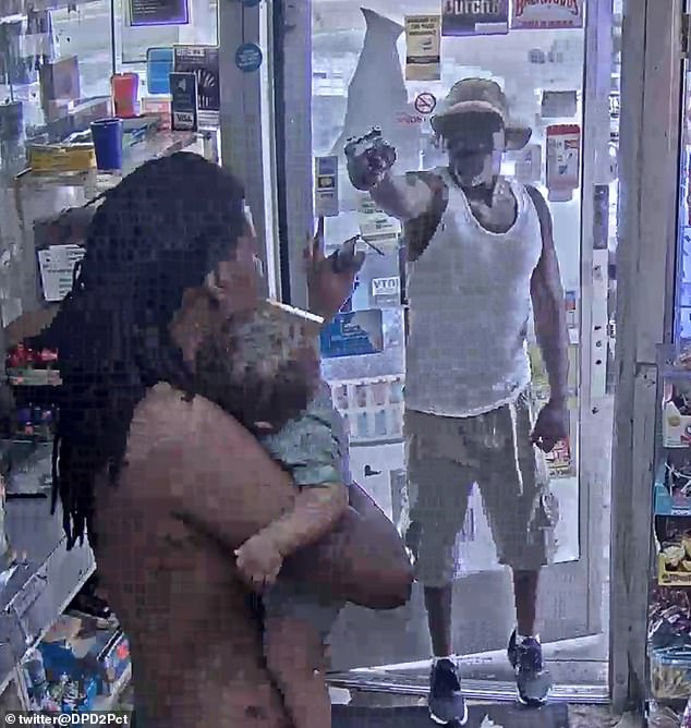 Moment Detroit man strolls into gas station in daylight before brandishing gun at man carrying baby